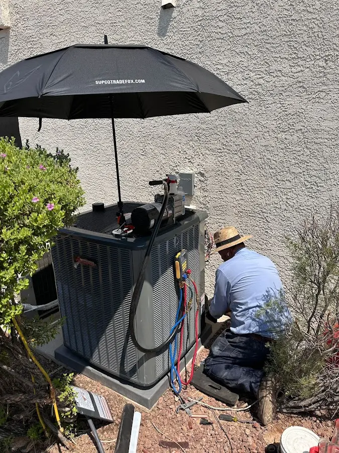 HVAC technician performing outdoor AC maintenance in Mount Olive