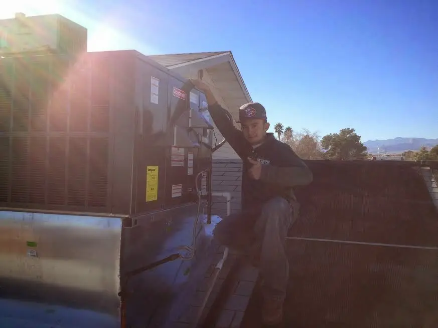 HVAC technician performing HVAC Inspection on a rooftop unit in Mount Olive